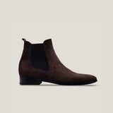 A dark brown suede Chelsea boot with a black elastic panel and a low heel.