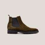 A camouflage green suede Chelsea boot with a black panel and a rubber sole.