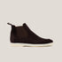 A dark brown suede Chelsea boot with a white sole.