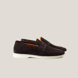 A pair of dark brown suede penny loafers with a white sole.