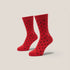 Red socks with black polka dots on a beige background